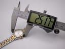 Digital caliper measuring the Seiko watch case, displaying a precise diameter of 25.17mm.