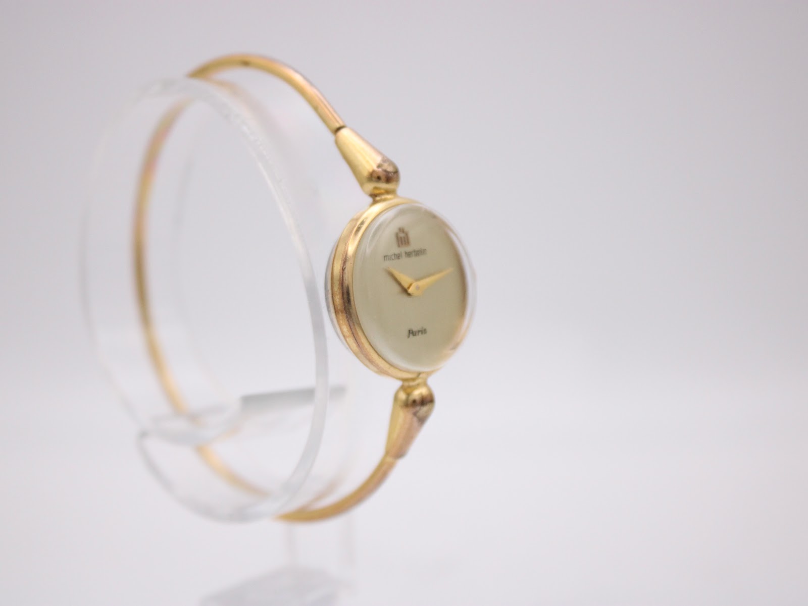 Side view of the Michel Herbelin watch highlighting the gold-tone case and bracelet, with the crown visible.