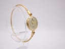 Side view of the Michel Herbelin watch highlighting the gold-tone case and bracelet, with the crown visible.