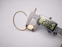 The watch case being measured by a digital caliper, displaying a precise diameter of 20.86mm.