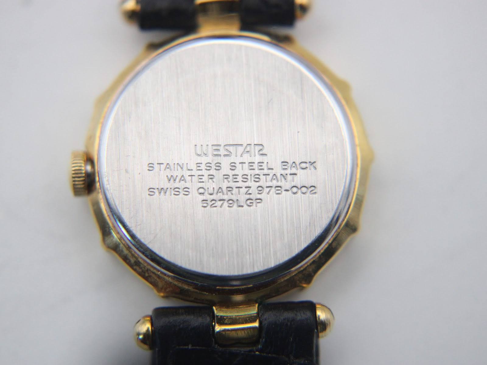 Close-up of the Westar stainless steel case back with model number and "water resistant" engraving.