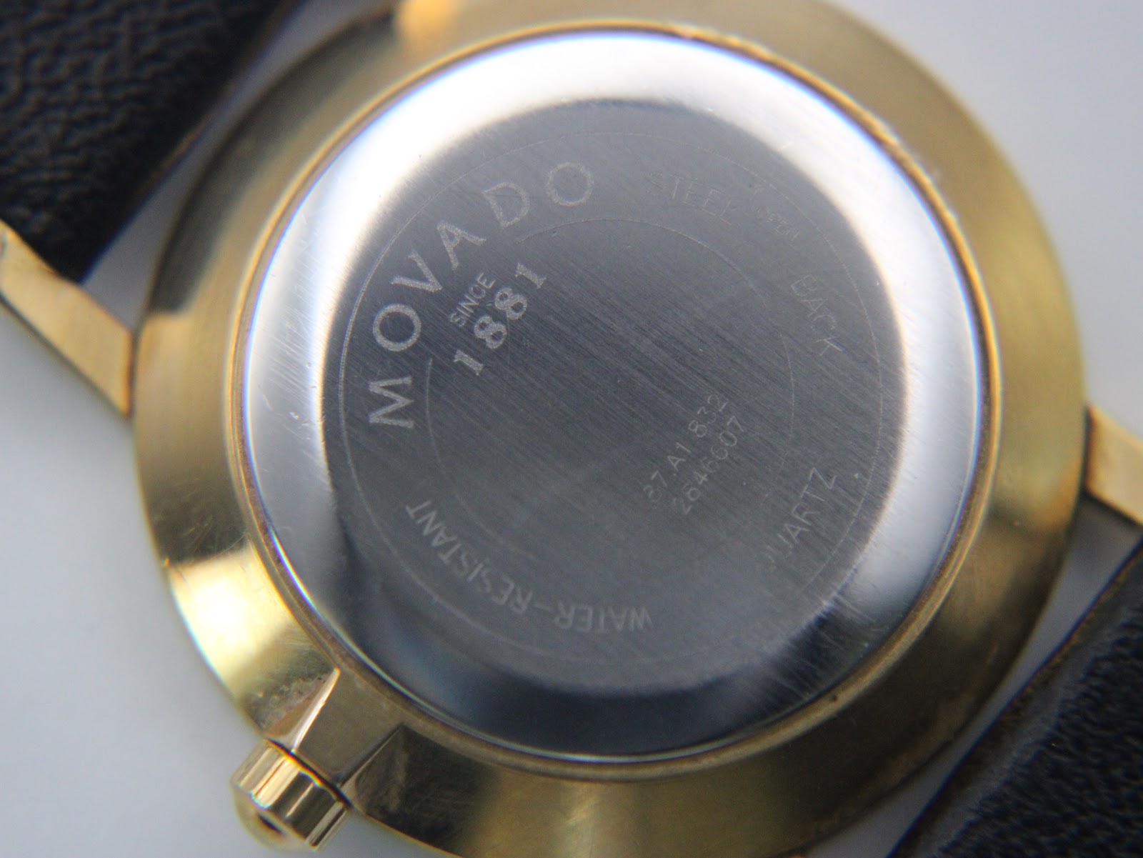 Detailed close-up of the watch's stainless steel case back, clearly showing "Movado Since 1881", model 27.A1.822, and serial number 2648607.