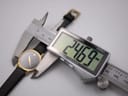 Digital caliper measuring the watch case diameter, displaying an exact measurement of 24.69mm.