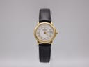Front view of the Raymond Weil 9972 ladies watch on a clear display stand, showing the white dial with gold Roman numerals and black leather strap.