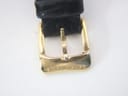 Close-up of the gold plated buckle, clearly showing the "Raymond Weil" signature engraved on it.