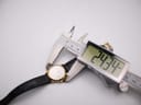 Digital caliper measuring the case diameter of the Raymond Weil 9972 watch, displaying a precise reading of 24.34mm.