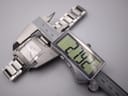 Digital caliper measuring the case width of the Gucci 7700 M watch, displaying an exact measurement of 27.92mm.