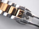 Close-up of the two-tone bracelet and the signed Bulova clasp with the tuning fork logo.