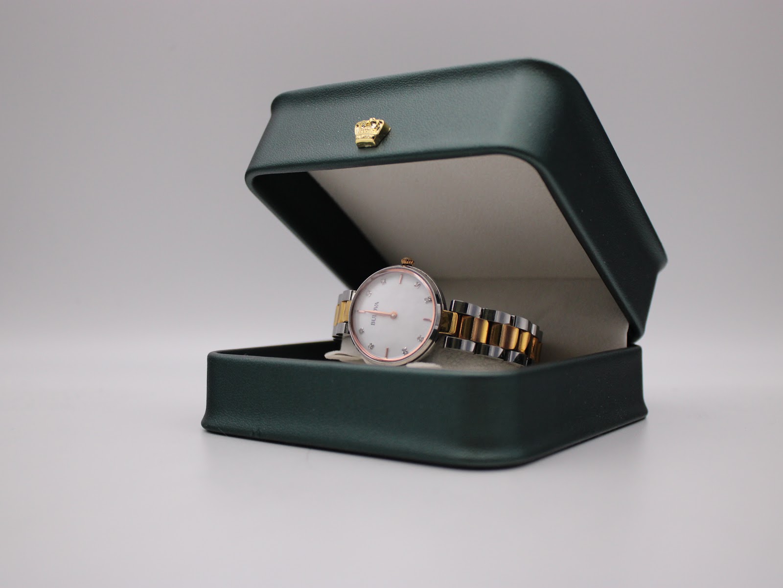The Bulova watch displayed in a green presentation box.