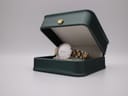 The Bulova watch displayed in a green presentation box.