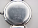 Close-up of the Michel Herbelin watch case back showing model 16836.B, 'Swiss Movt', 'Made in France', and '30 m' water resistance.