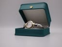 Michel Herbelin watch displayed open in a generic green watch box.