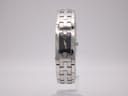 Front view of the Tissot L820P watch with its rectangular black dial and integrated silver stainless steel bracelet, standing upright.