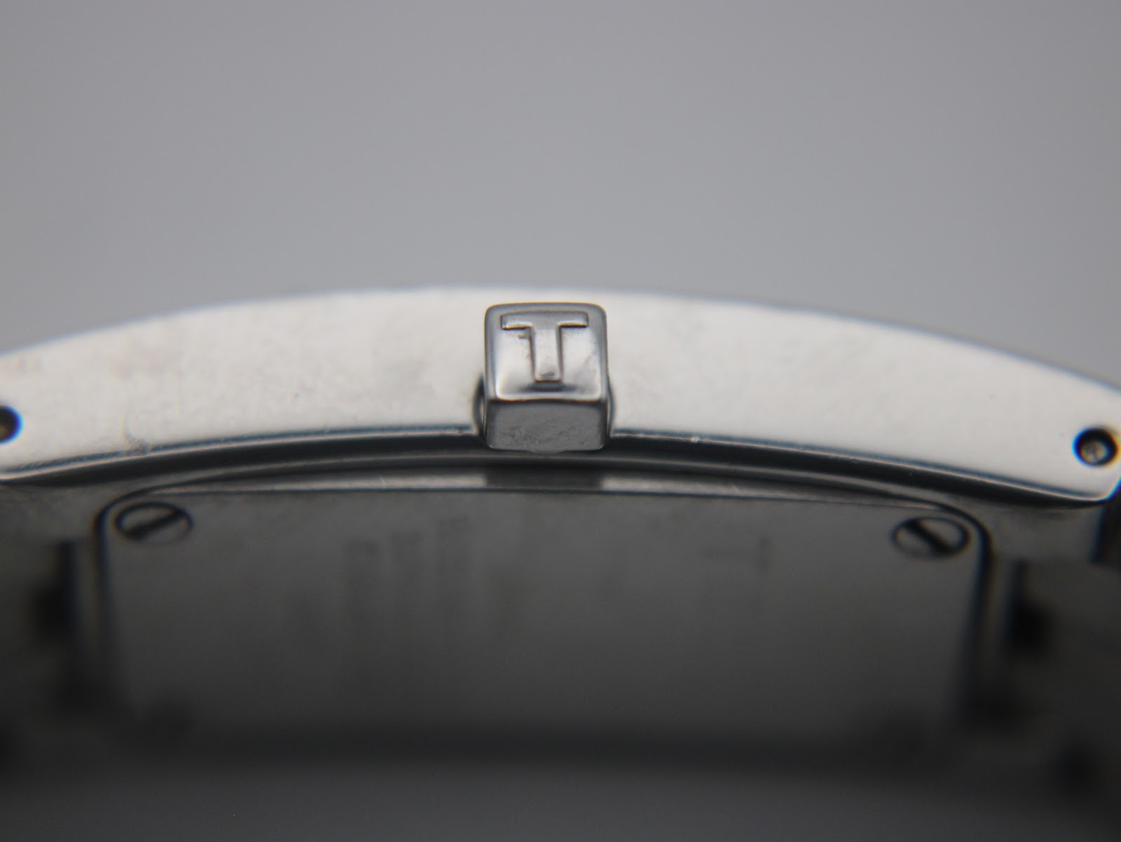 Close-up of the watch's crown, featuring the distinct 'T' logo of Tissot.
