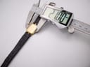 Close-up showing a digital caliper measuring the watch case, displaying a precise measurement of '21.00 mm'.