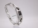 Three-quarter view of the Gucci 6100L, showcasing the overall design of the watch and bracelet on a clear stand.
