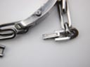 Detail shot of the watch crown and the integrated bracelet clasp mechanism, revealing some minor wear.