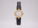 Front view of Certina ladies' watch on stand, gold case, white Roman dial, black leather strap.