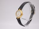 Angled left view of Certina ladies' watch on stand, showing gold case and black leather strap.