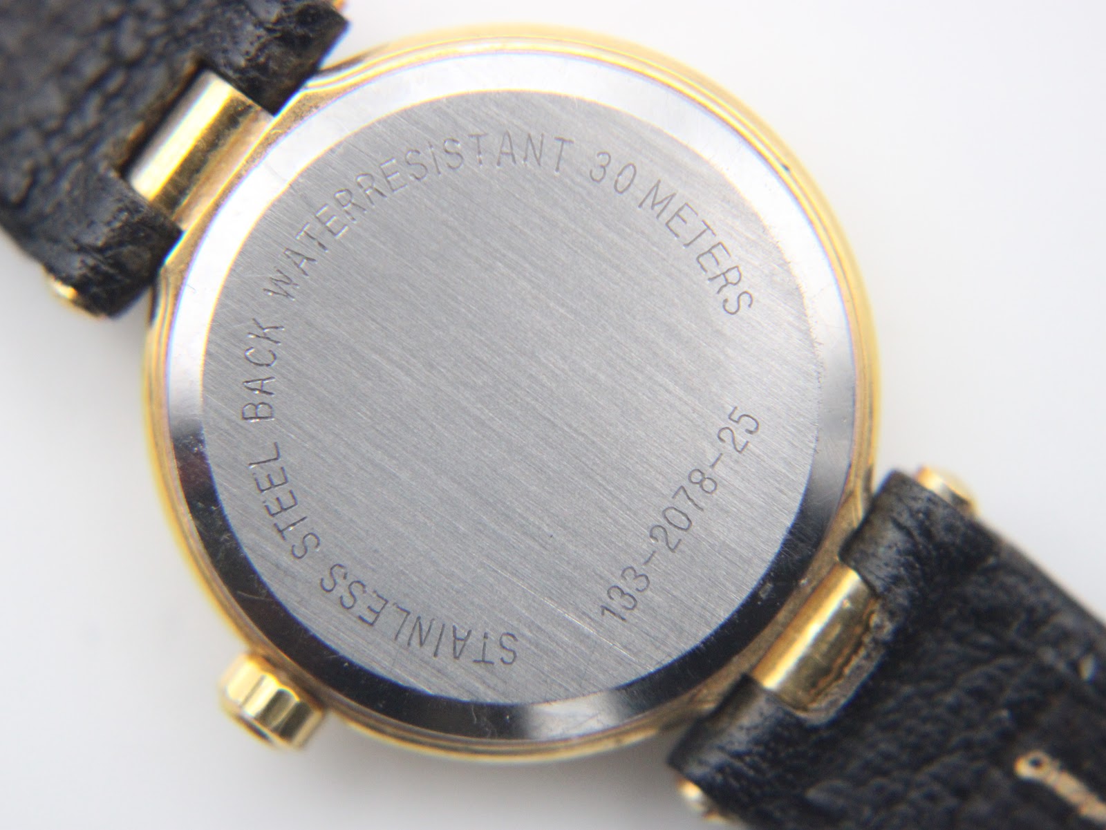 Close-up of stainless steel case back with 'waterresistant 30 meters' and model number '133-2078-25' engravings.