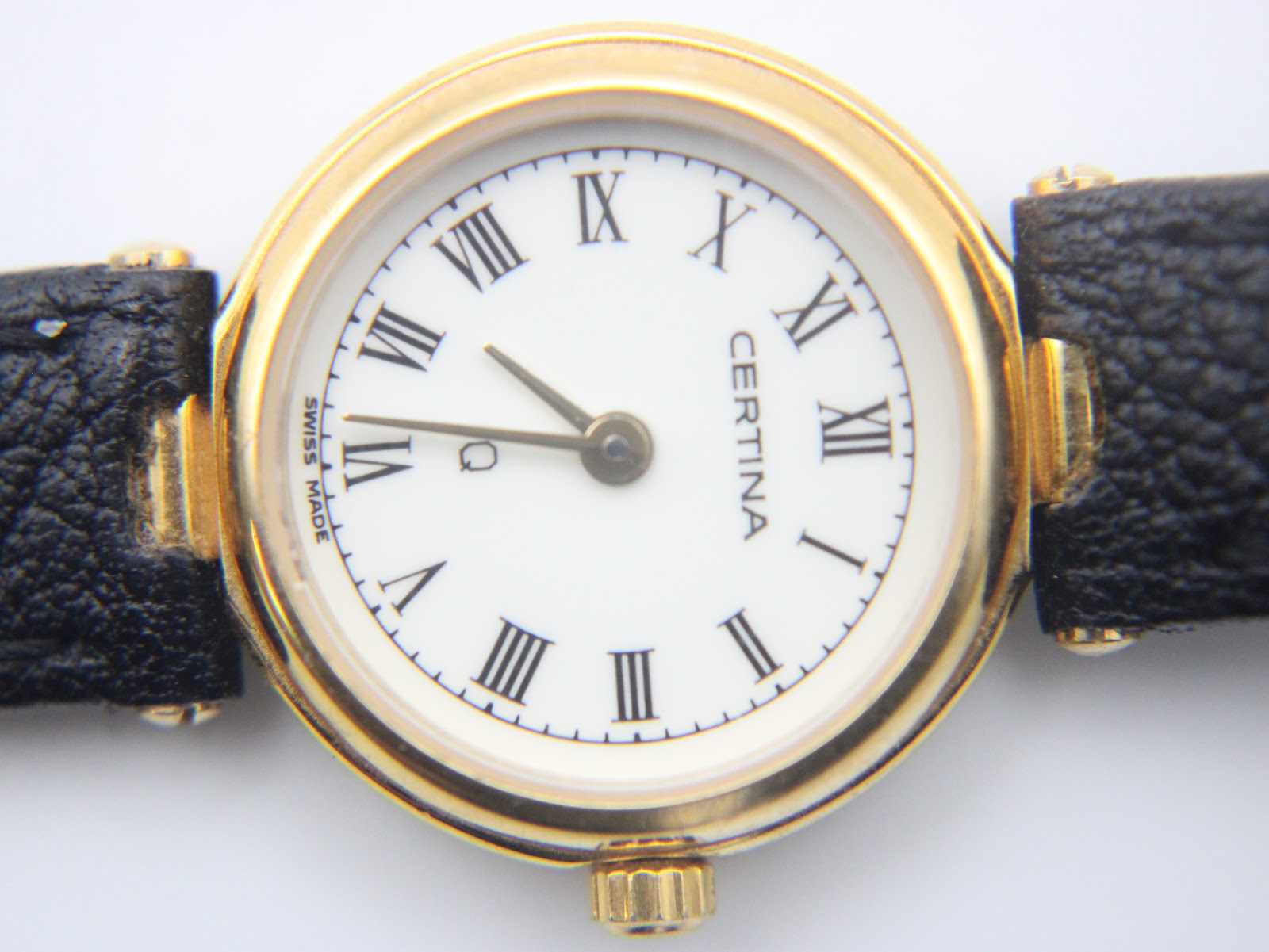 Detailed close-up of the Certina white dial with black Roman numerals and 'Swiss Made' text.