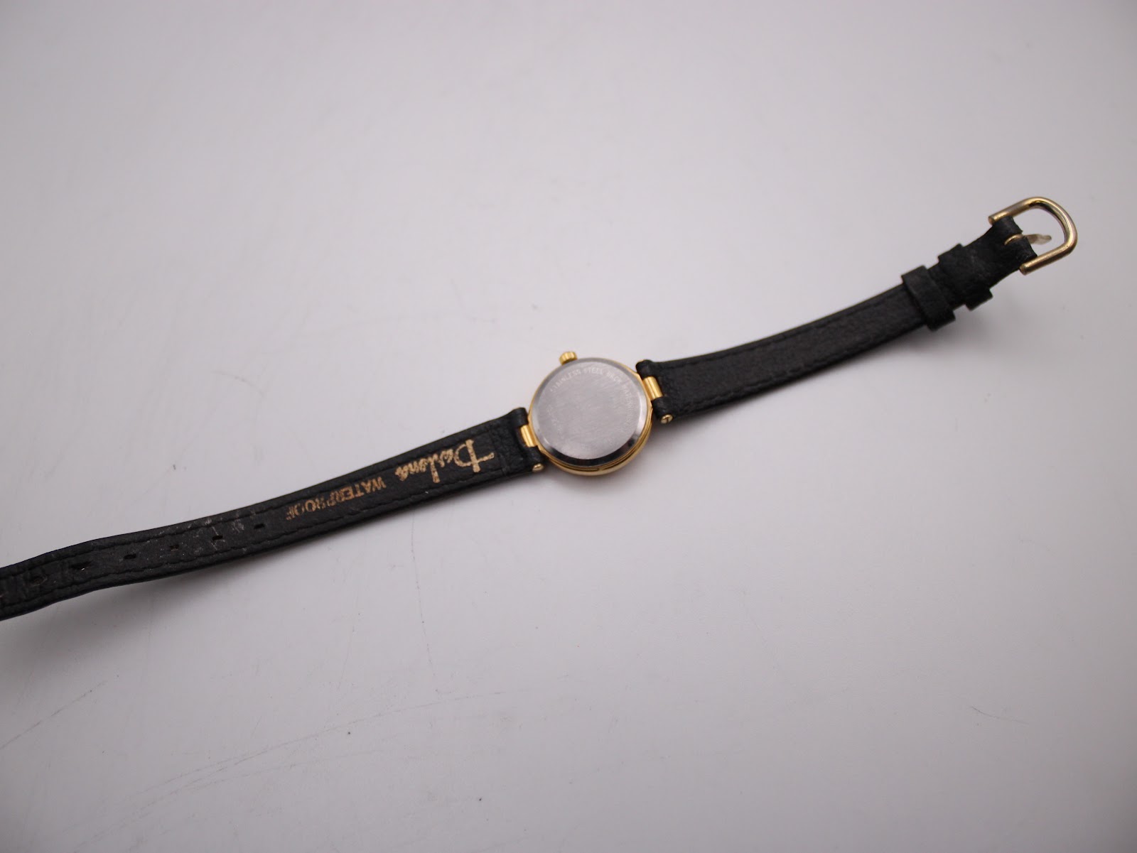 Back view of Certina watch on black leather strap showing generic buckle and strap branding.