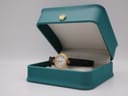 Certina watch displayed in an open teal gift box with a gold crown emblem.