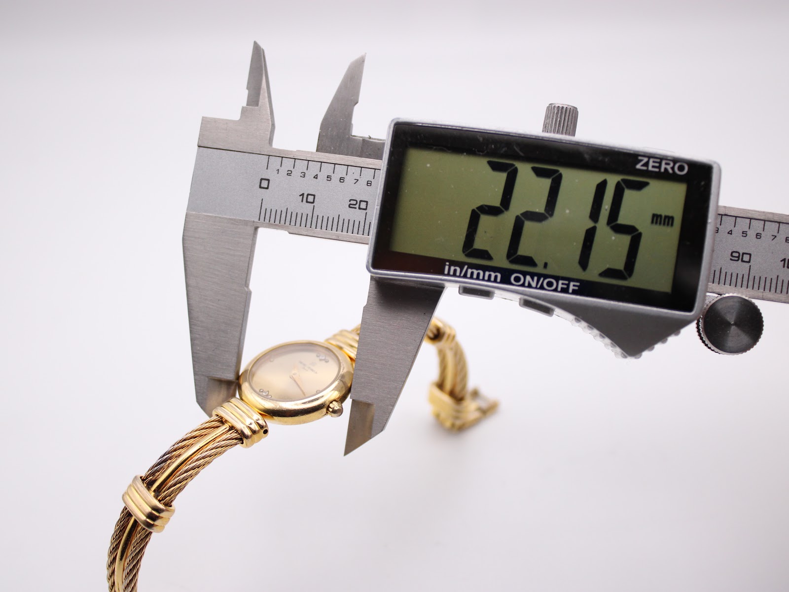 Digital caliper measuring the case diameter of the watch at 22.15mm.