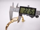 Digital caliper measuring the case diameter of the watch at 22.15mm.