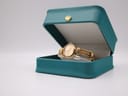 The Michel Herbelin watch displayed open in a dark green presentation box.
