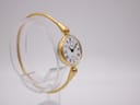 Angled side view of the Michel Herbelin ladies' watch, highlighting its gold tone case and integrated bangle design.