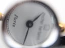 Extreme close-up of the watch dial, showing the Michel Herbelin logo, 'Paris' text, and crisp black Roman numeral hour markers.