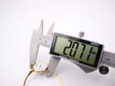A digital caliper precisely measuring the watch case diameter at 20.71mm, with the watch resting on a white surface.