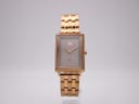 Front view of MVMT Signature Square watch with rose gold tone rectangular case and dark brown dial on a white background.