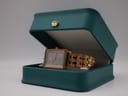 Angled view of the MVMT Signature Square watch presented in a decorative teal watch box with a gold crown emblem.