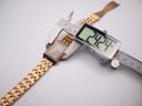 Overhead view of the MVMT Signature Square watch with a digital caliper measuring the case width at 24.24mm.