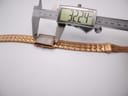 Overhead view of the MVMT Signature Square watch with a digital caliper measuring the case length at 32.24mm.