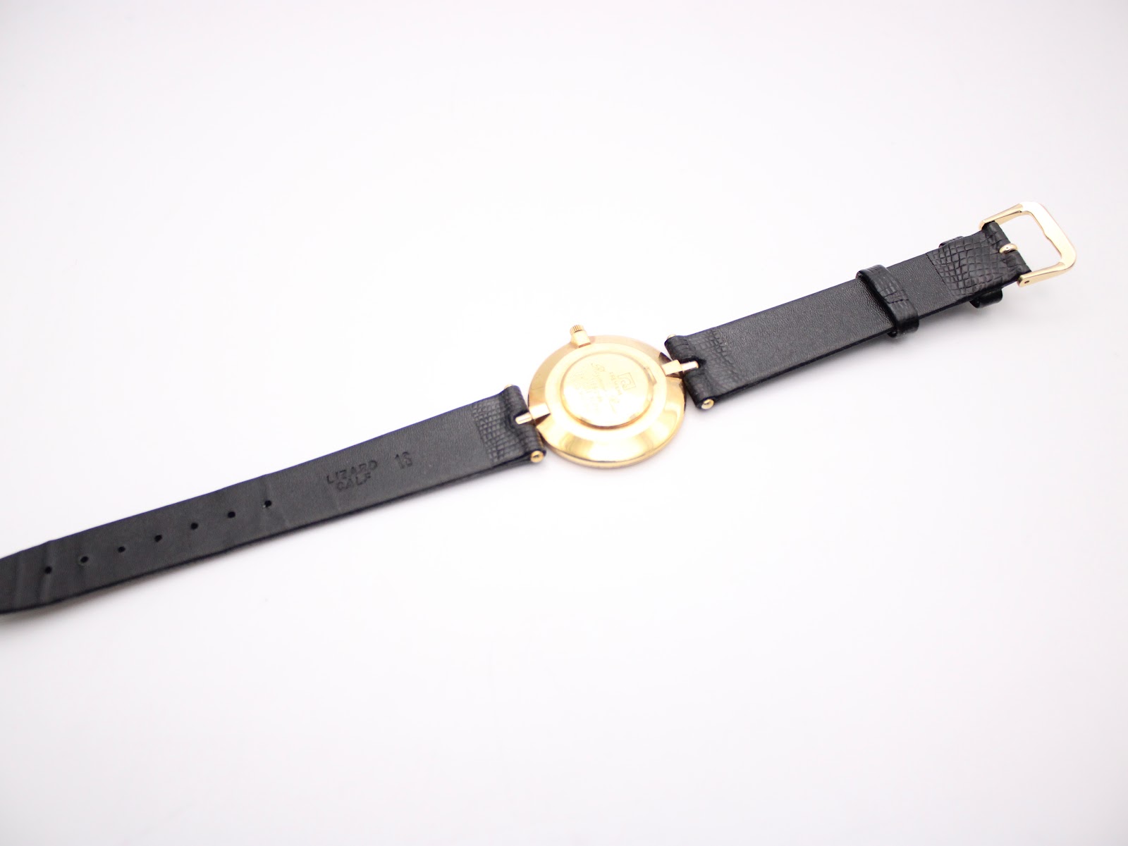 Rear view of the black leather strap, showing 'LIZARD CALF 16' marking the lug width and material.
