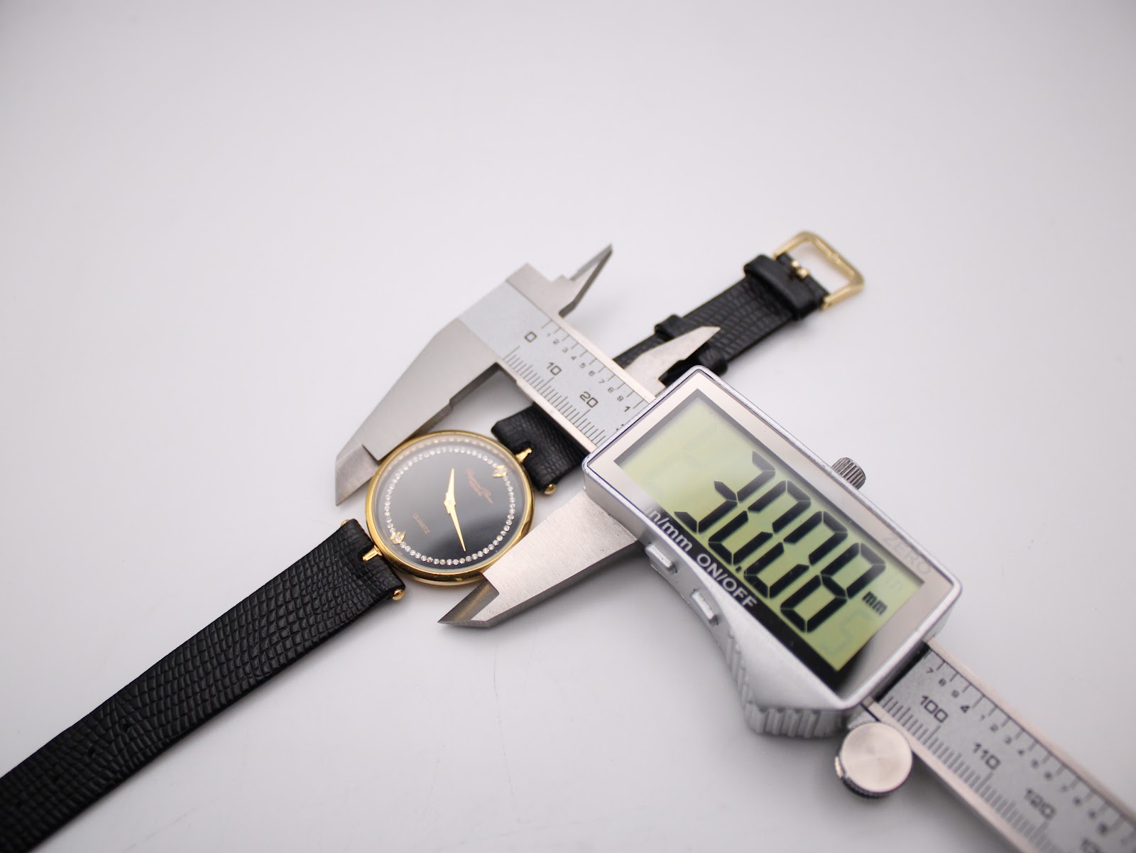 Digital caliper measuring the watch case diameter at 30.8 mm.