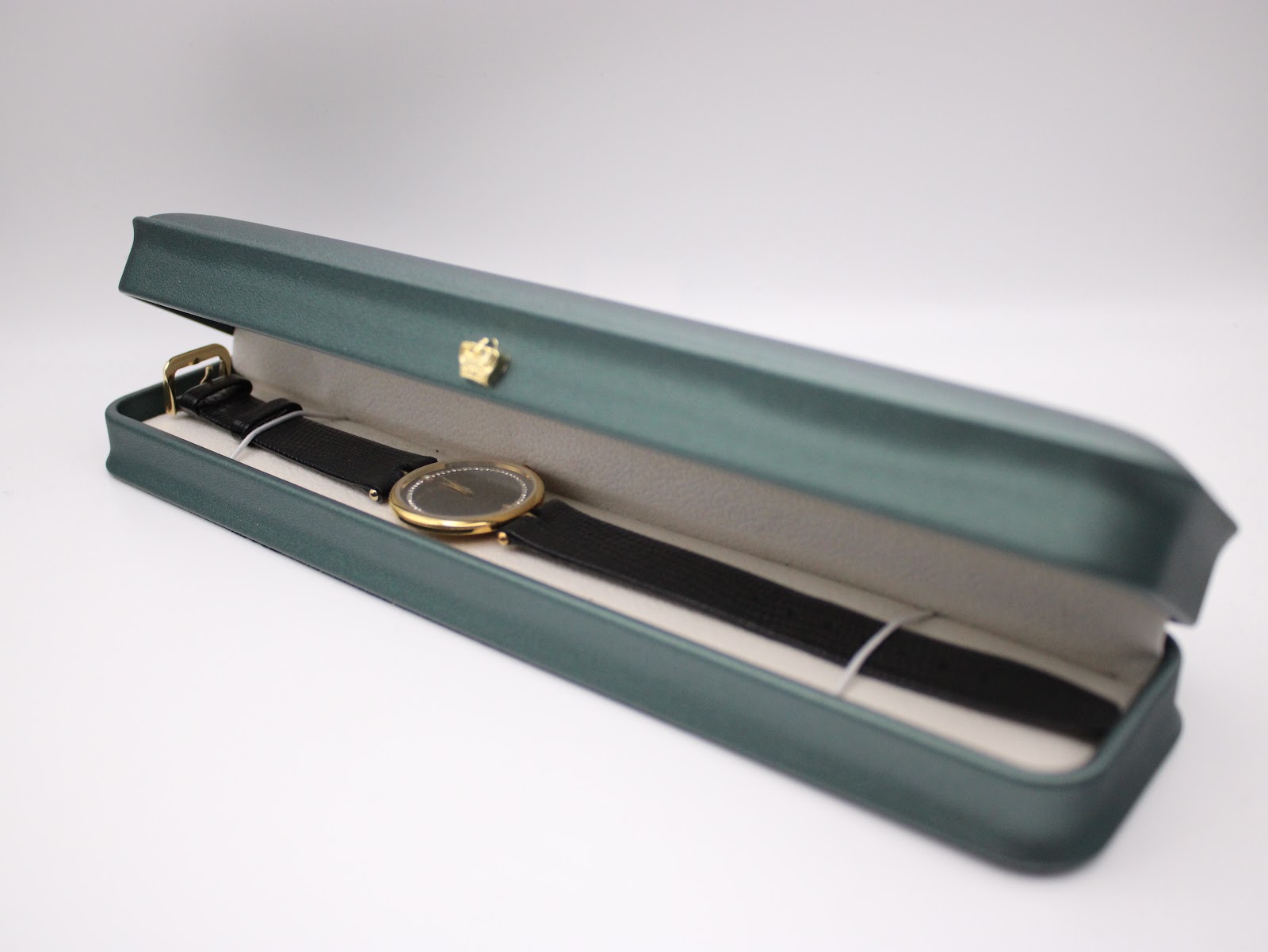 The Raymond Rone watch neatly presented inside a green rectangular watch box.