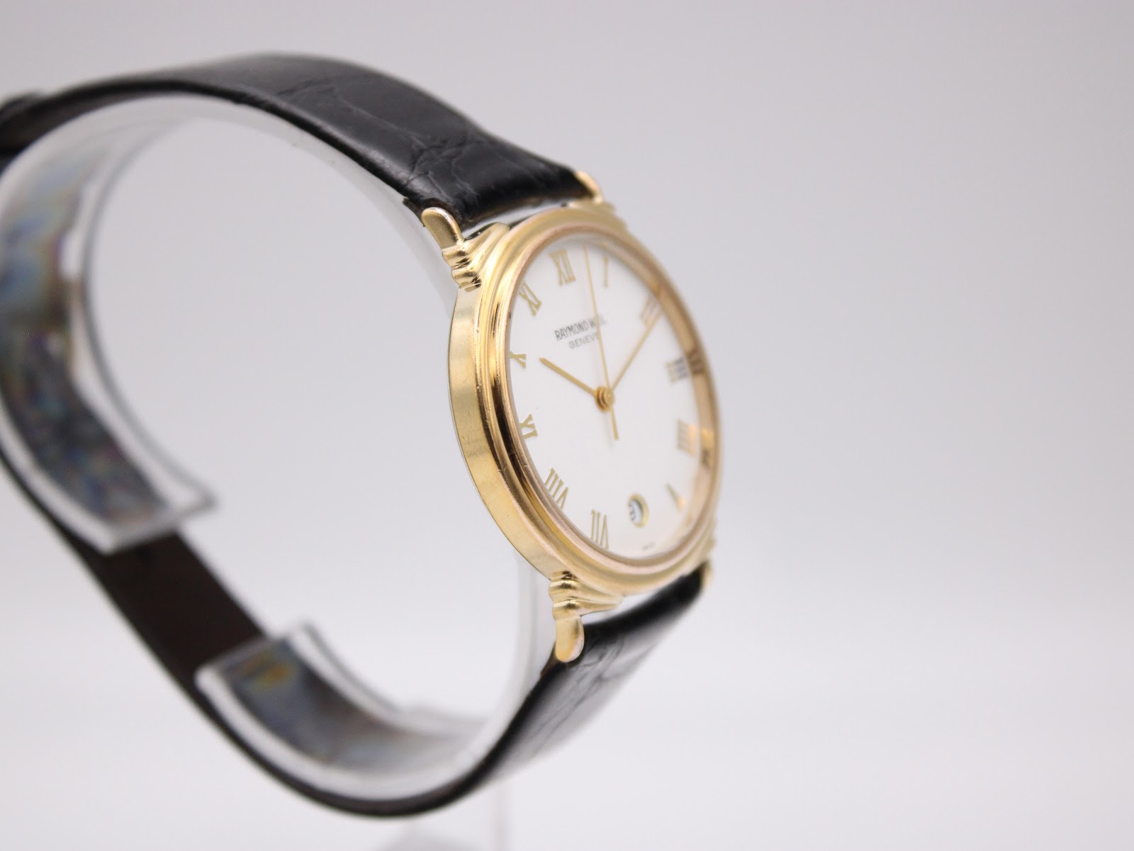 Another angled side view of the Raymond Weil watch, highlighting the case profile and fluted crown.