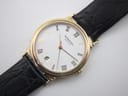 Overhead angled view of the Raymond Weil dial, showing the date window at 6 o'clock and gold hands.