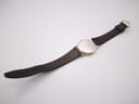 Back view of the watch and strap, showing the underside of the black leather strap.