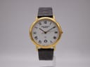 Front view of a Jean Perret QJ quartz watch with a gold-tone case and white Roman numeral dial on a stand.