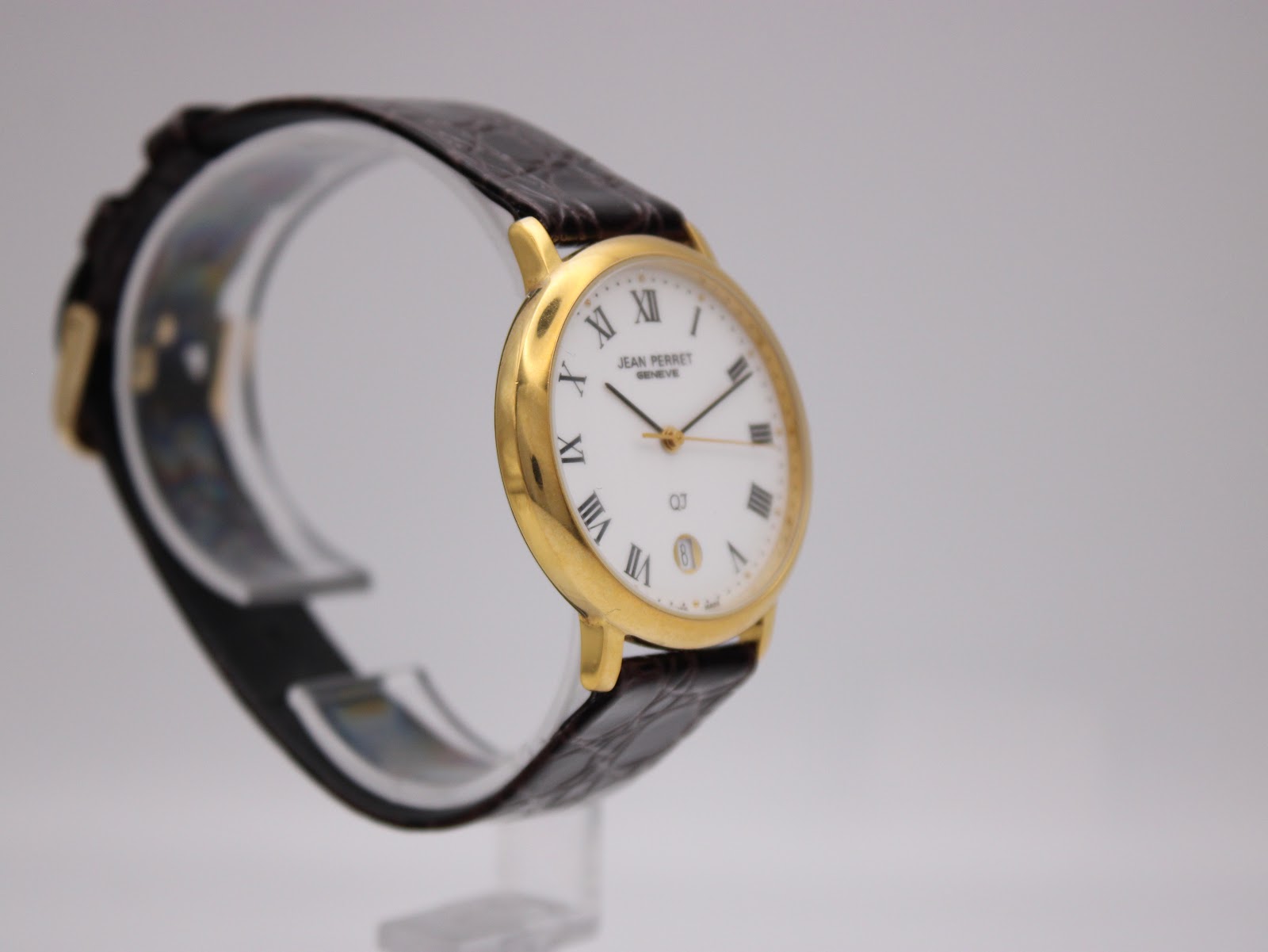 Another angled side view of the Jean Perret QJ watch, showing the crown and case profile.