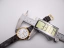 Close-up of the Jean Perret QJ watch being measured by a digital caliper, displaying a case size of 33.1mm.