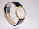 Another angled view of the Tissot watch, highlighting the slim profile and gold-tone finish.
