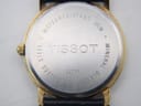 Close-up of the stainless steel case back with "TISSOT C276K", "WATERRESISTANT 30M", "STEEL", "MINERAL GLASS" engravings.
