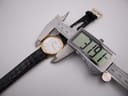 Digital caliper measuring the case diameter of the Tissot watch, displaying 31.9mm.