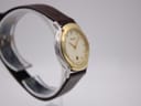 Another angled side view of the watch, highlighting the case profile and brown leather strap from the other side.